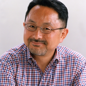 Portrait of a smiling man with glasses and a checked shirt