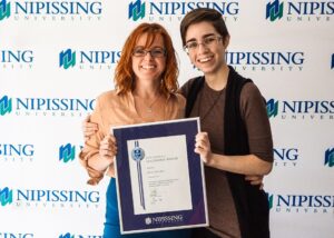 Dave Marshall Leadership Awards photo of a recipient or guests in front of a Nipissing University backdrop