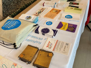 A table of pamphlets, buttons, bags and cards from consent and sexual violence support organizations