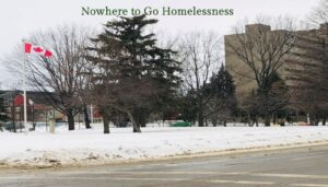 Presentation slide titled 'Nowhere to Go Homelessness' showing a snowy park with a Canadian flag and a high-rise building
