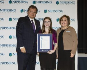Dave Marshall Leadership Awards photo of a recipient or guests in front of a Nipissing University backdrop