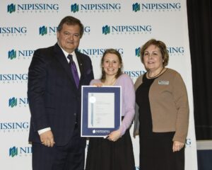 Dave Marshall Leadership Awards photo of a recipient or guests in front of a Nipissing University backdrop