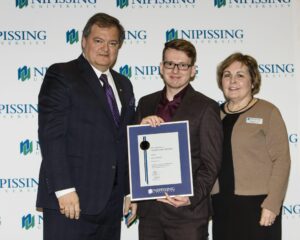 Dave Marshall Leadership Awards photo of a recipient or guests in front of a Nipissing University backdrop