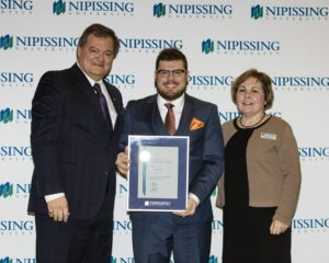 Dave Marshall Leadership Awards photo of a recipient or guests in front of a Nipissing University backdrop