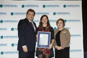 Dave Marshall Leadership Awards photo of a recipient or guests in front of a Nipissing University backdrop