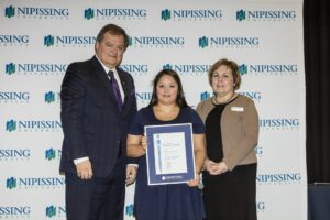 Dave Marshall Leadership Awards photo of a recipient or guests in front of a Nipissing University backdrop