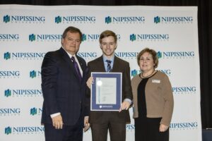Dave Marshall Leadership Awards photo of a recipient or guests in front of a Nipissing University backdrop
