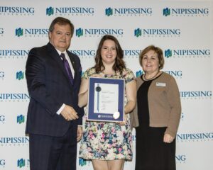 Dave Marshall Leadership Awards photo of a recipient or guests in front of a Nipissing University backdrop