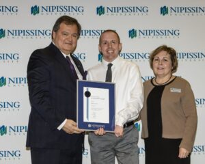 Dave Marshall Leadership Awards photo of a recipient or guests in front of a Nipissing University backdrop