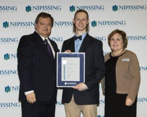 Dave Marshall Leadership Awards photo of a recipient or guests in front of a Nipissing University backdrop