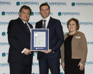 Dave Marshall Leadership Awards photo of a recipient or guests in front of a Nipissing University backdrop