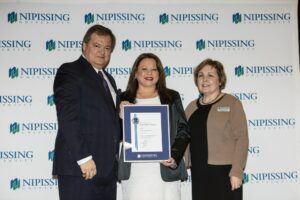 Dave Marshall Leadership Awards photo of a recipient or guests in front of a Nipissing University backdrop
