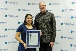 Dave Marshall Leadership Awards photo of a recipient or guests in front of a Nipissing University backdrop