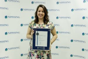 Dave Marshall Leadership Awards photo of a recipient or guests in front of a Nipissing University backdrop