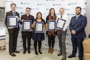 Dave Marshall Leadership Awards photo of a recipient or guests in front of a Nipissing University backdrop