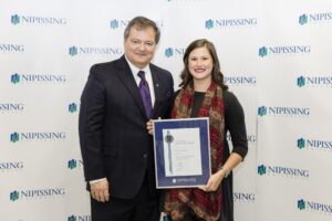 Dave Marshall Leadership Awards photo of a recipient or guests in front of a Nipissing University backdrop