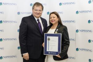 Dave Marshall Leadership Awards photo of a recipient or guests in front of a Nipissing University backdrop