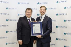 Dave Marshall Leadership Awards photo of a recipient or guests in front of a Nipissing University backdrop
