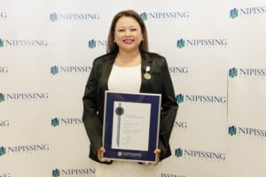 Dave Marshall Leadership Awards photo of a recipient or guests in front of a Nipissing University backdrop