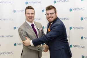 Dave Marshall Leadership Awards photo of a recipient or guests in front of a Nipissing University backdrop