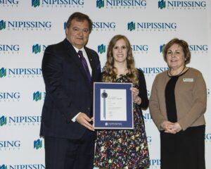 Dave Marshall Leadership Awards photo of a recipient or guests in front of a Nipissing University backdrop