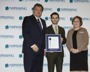 Dave Marshall Leadership Awards photo of a recipient or guests in front of a Nipissing University backdrop