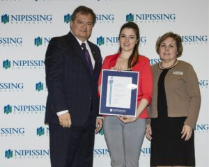 Dave Marshall Leadership Awards photo of a recipient or guests in front of a Nipissing University backdrop