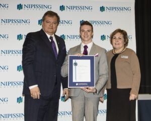 Dave Marshall Leadership Awards photo of a recipient or guests in front of a Nipissing University backdrop