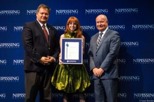 Dave Marshall Leadership Awards photo of a recipient or guests in front of a Nipissing University backdrop
