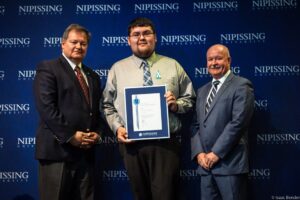 Dave Marshall Leadership Awards photo of a recipient or guests in front of a Nipissing University backdrop