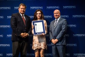 Dave Marshall Leadership Awards photo of a recipient or guests in front of a Nipissing University backdrop