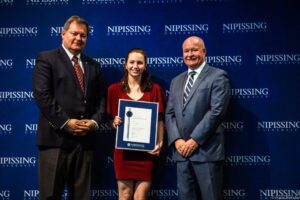 Dave Marshall Leadership Awards photo of a recipient or guests in front of a Nipissing University backdrop
