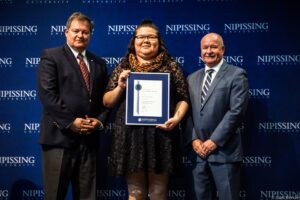Dave Marshall Leadership Awards photo of a recipient or guests in front of a Nipissing University backdrop
