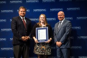 Dave Marshall Leadership Awards photo of a recipient or guests in front of a Nipissing University backdrop
