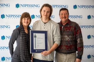 Dave Marshall Leadership Awards photo of a recipient or guests in front of a Nipissing University backdrop