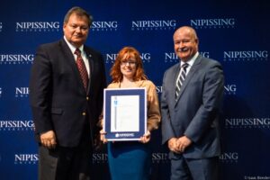 Dave Marshall Leadership Awards photo of a recipient or guests in front of a Nipissing University backdrop