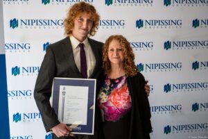 Dave Marshall Leadership Awards photo of a recipient or guests in front of a Nipissing University backdrop