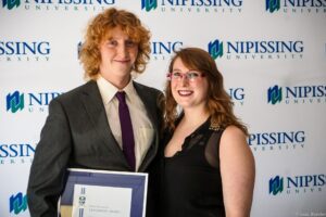 Dave Marshall Leadership Awards photo of a recipient or guests in front of a Nipissing University backdrop