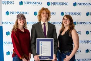 Dave Marshall Leadership Awards photo of a recipient or guests in front of a Nipissing University backdrop