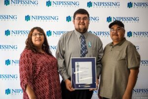 Dave Marshall Leadership Awards photo of a recipient or guests in front of a Nipissing University backdrop