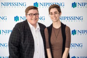 Dave Marshall Leadership Awards photo of a recipient or guests in front of a Nipissing University backdrop