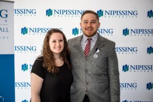 Dave Marshall Leadership Awards photo of a recipient or guests in front of a Nipissing University backdrop