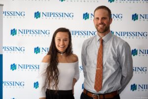 Dave Marshall Leadership Awards photo of a recipient or guests in front of a Nipissing University backdrop