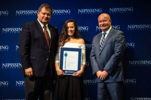 Dave Marshall Leadership Awards photo of a recipient or guests in front of a Nipissing University backdrop