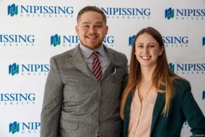 Dave Marshall Leadership Awards photo of a recipient or guests in front of a Nipissing University backdrop