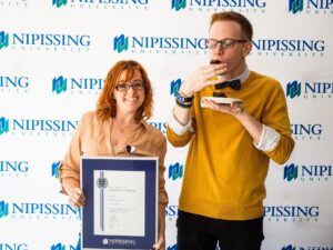 Dave Marshall Leadership Awards photo of a recipient or guests in front of a Nipissing University backdrop