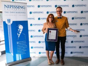 Dave Marshall Leadership Awards photo of a recipient or guests in front of a Nipissing University backdrop