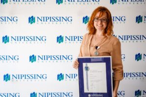 Dave Marshall Leadership Awards photo of a recipient or guests in front of a Nipissing University backdrop