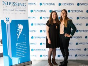 Dave Marshall Leadership Awards photo of a recipient or guests in front of a Nipissing University backdrop