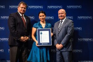 Dave Marshall Leadership Awards photo of a recipient or guests in front of a Nipissing University backdrop